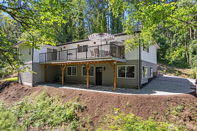 rear view of house featuring a wooden deck