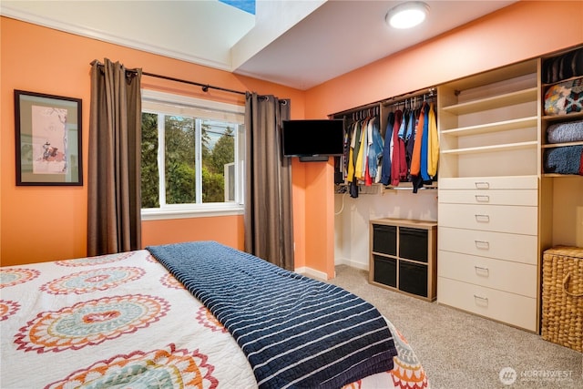 carpeted bedroom with a closet and baseboards