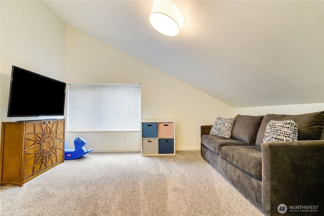 living area with vaulted ceiling, baseboards, and carpet floors