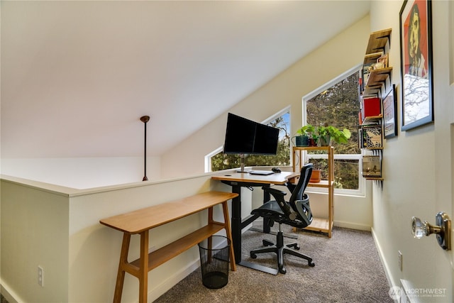 office space featuring baseboards, lofted ceiling, and carpet