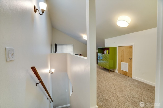 stairs with visible vents, lofted ceiling, and carpet floors