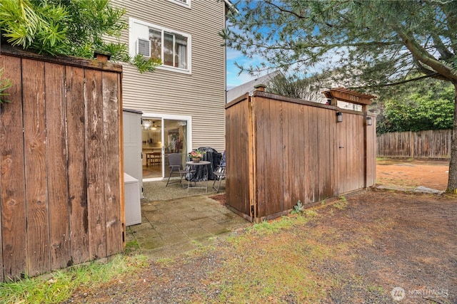 view of shed with fence