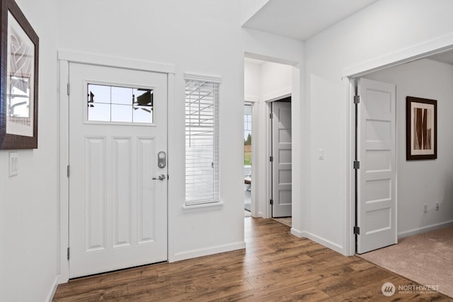 foyer with wood finished floors and baseboards