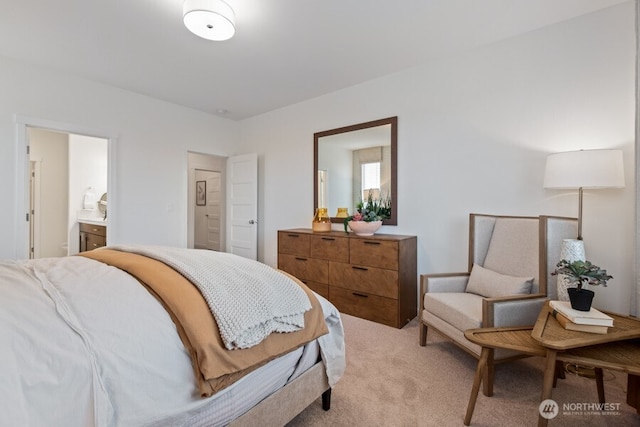 bedroom with light carpet and connected bathroom