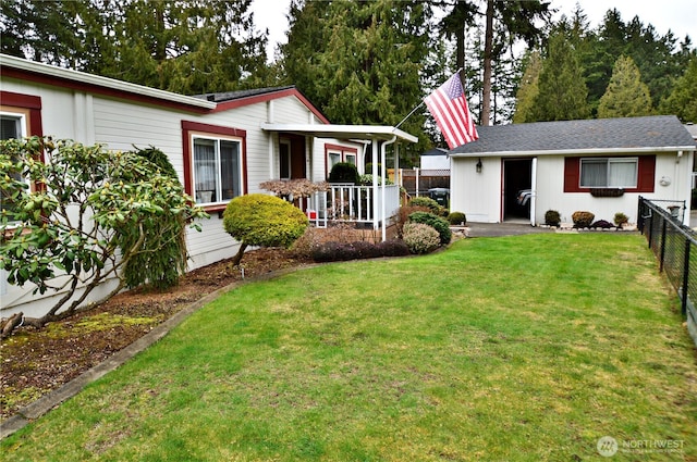 view of front of home featuring covered porch, fence, and a front yard