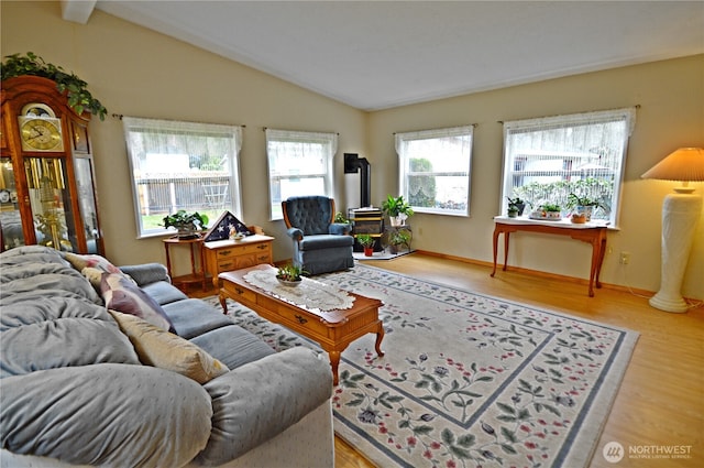 living area with vaulted ceiling and wood finished floors