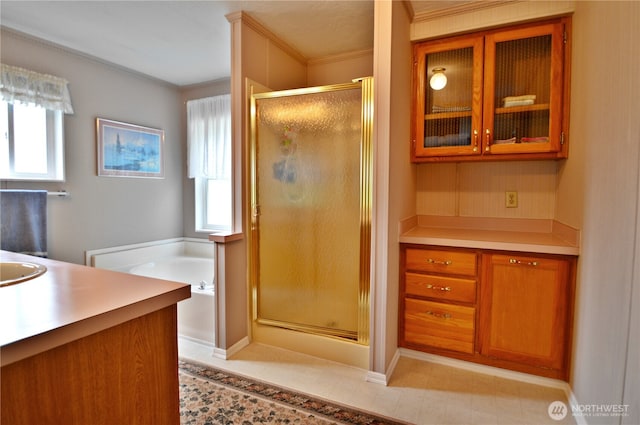 full bathroom featuring a stall shower, plenty of natural light, vanity, and a bath