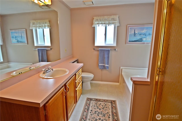 bathroom featuring baseboards, toilet, ornamental molding, a garden tub, and vanity