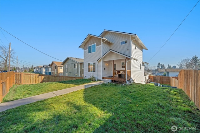 view of front of home featuring a fenced backyard and a front lawn