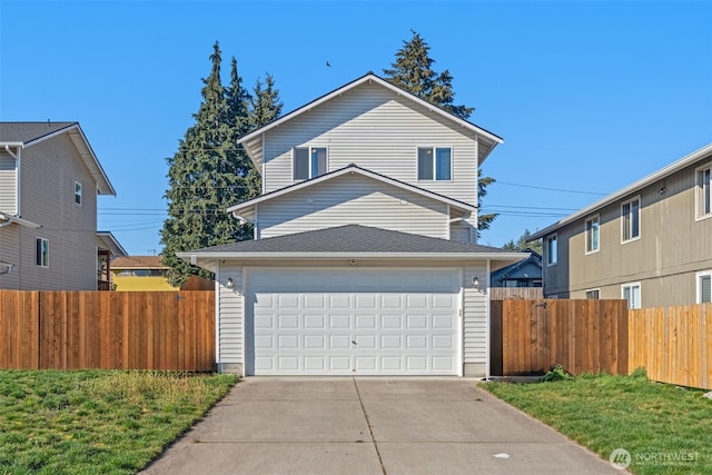 traditional-style home featuring a garage, fence, and driveway