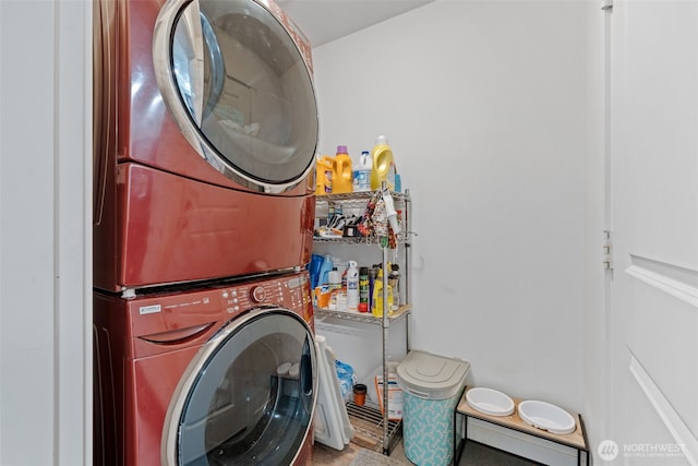 clothes washing area with stacked washer and dryer and laundry area