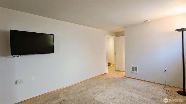 interior space with visible vents, carpet, and baseboards