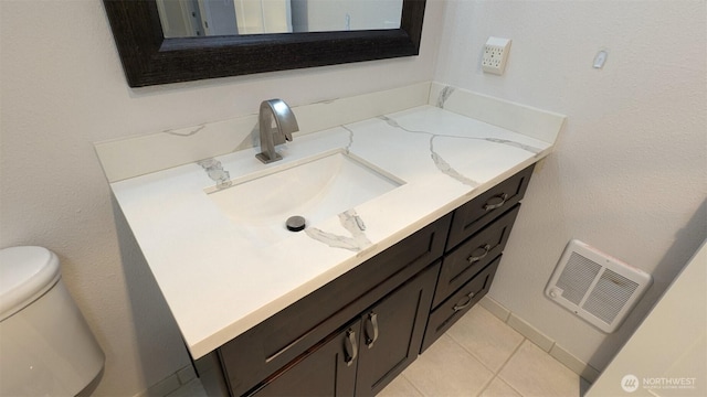 bathroom featuring vanity, tile patterned floors, toilet, and visible vents