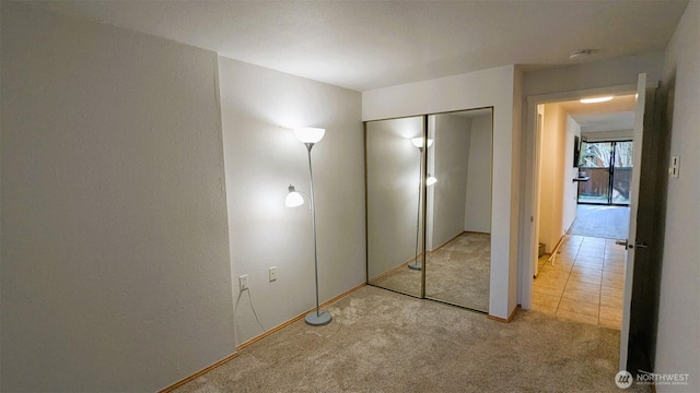 unfurnished bedroom featuring a closet and carpet floors