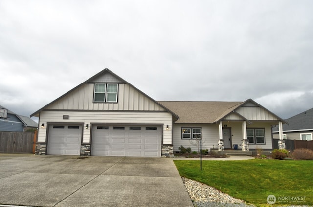 craftsman-style home with a porch, fence, concrete driveway, board and batten siding, and a front yard