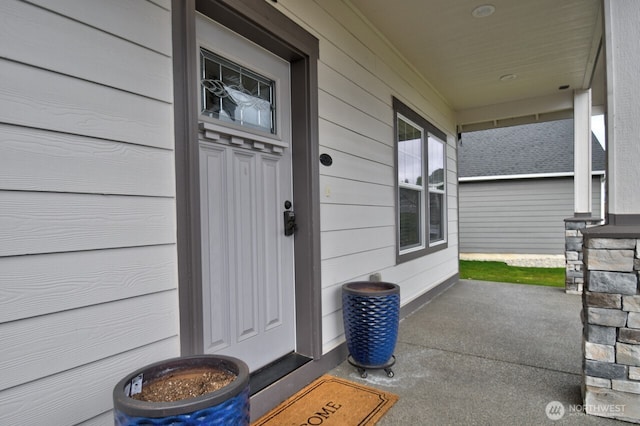 view of exterior entry with a porch