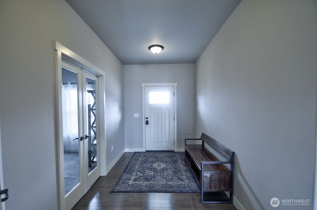 entryway with french doors, wood finished floors, and baseboards