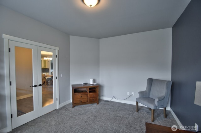 living area featuring french doors, carpet, and baseboards