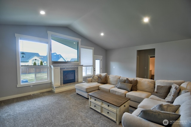 living area with baseboards, lofted ceiling, a premium fireplace, carpet floors, and recessed lighting