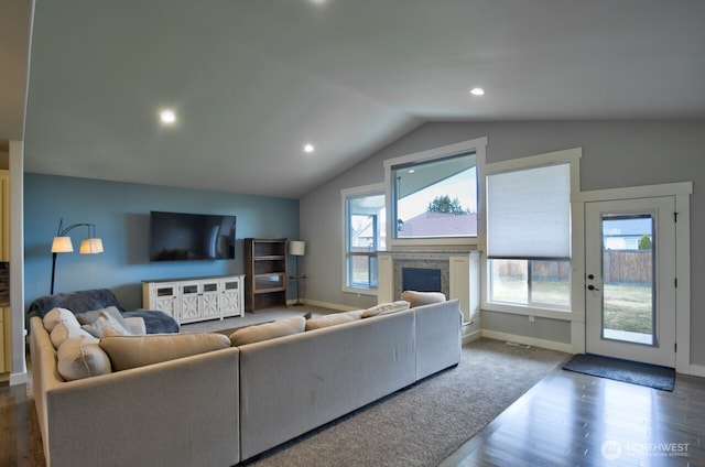 living area featuring lofted ceiling, recessed lighting, a fireplace, baseboards, and dark wood finished floors