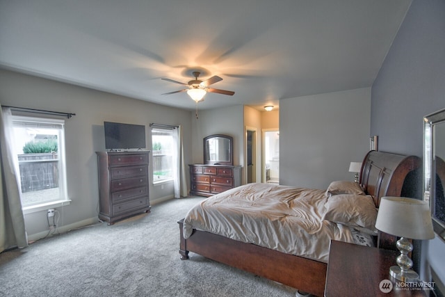 bedroom featuring ceiling fan, baseboards, connected bathroom, and light colored carpet