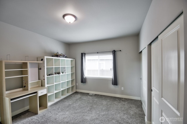 unfurnished bedroom with carpet and baseboards