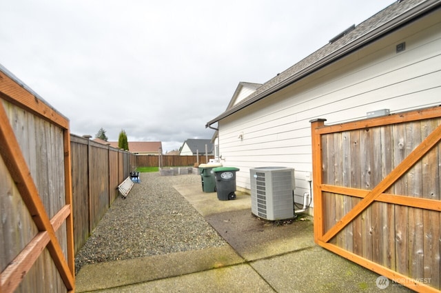 exterior space featuring central AC and a fenced backyard