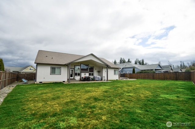 back of house featuring a patio, a lawn, and a fenced backyard