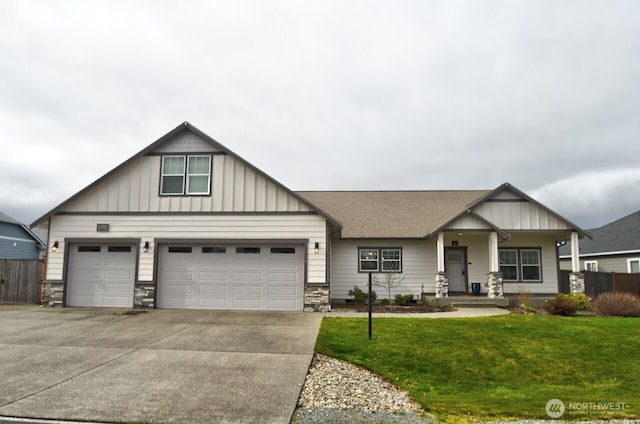 craftsman-style house featuring driveway, a shingled roof, fence, a front lawn, and board and batten siding