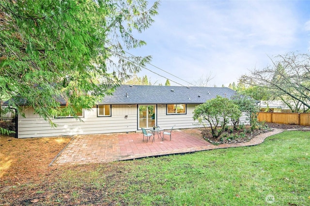 back of house with a patio, a yard, and fence