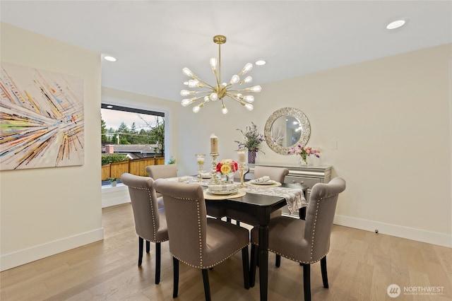 dining area featuring light wood-style floors, baseboards, a notable chandelier, and recessed lighting