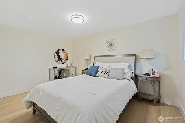 bedroom featuring baseboards and wood finished floors