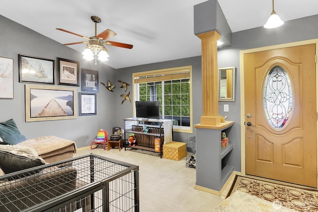 interior space with lofted ceiling, ceiling fan, carpet, and decorative columns