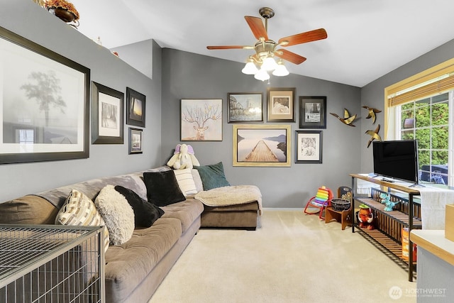 living area with carpet floors, ceiling fan, baseboards, and lofted ceiling