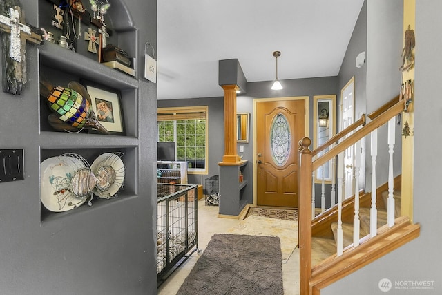 entryway with ornate columns and stairs