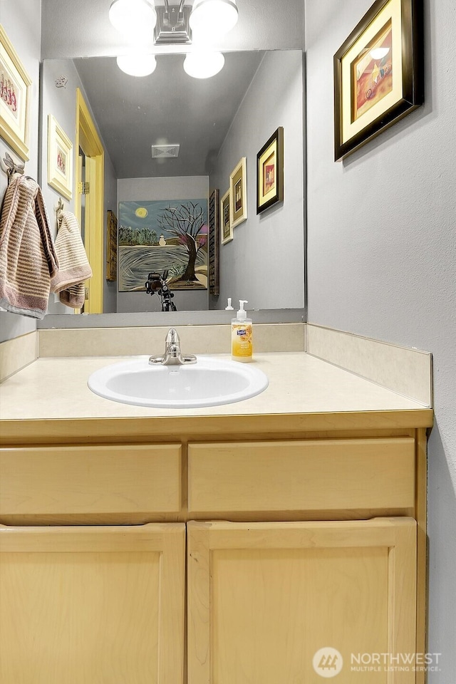 bathroom with vanity and visible vents