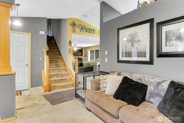 tiled living room with carpet, vaulted ceiling, and stairway