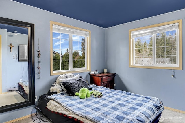 bedroom featuring baseboards and carpet flooring