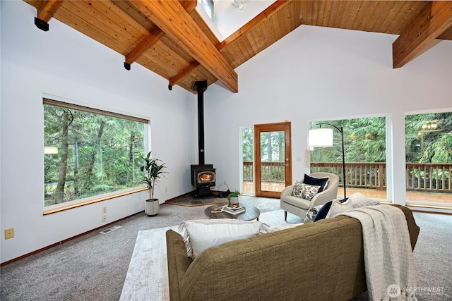 carpeted living room with high vaulted ceiling, visible vents, wood ceiling, beamed ceiling, and a wood stove