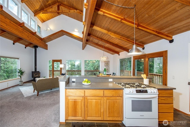 kitchen featuring white gas range oven, wood ceiling, open floor plan, beamed ceiling, and a wood stove