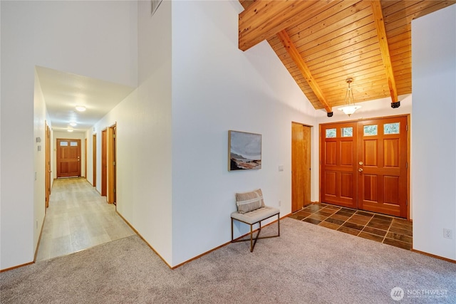 entrance foyer featuring high vaulted ceiling, carpet, beam ceiling, and wooden ceiling