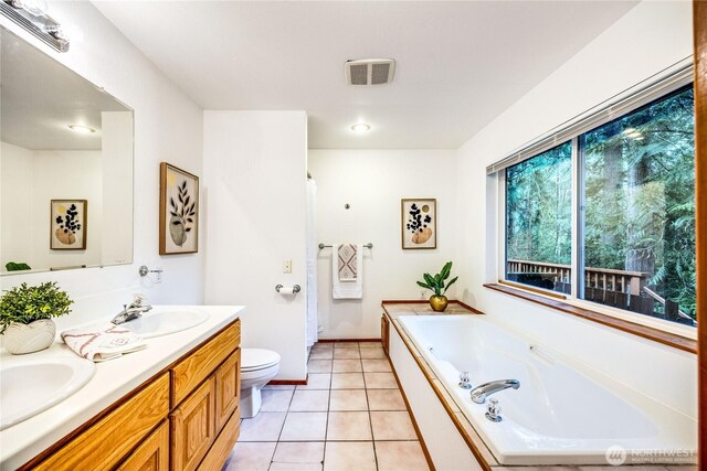 bathroom featuring visible vents, toilet, a garden tub, tile patterned flooring, and a sink