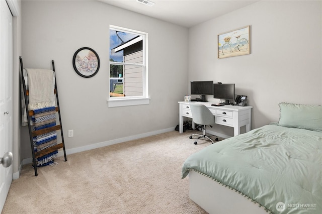 carpeted bedroom featuring visible vents and baseboards