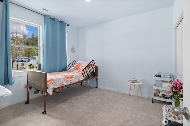 carpeted bedroom with baseboards and visible vents