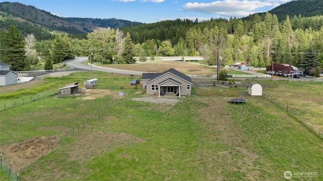 birds eye view of property with a forest view and a mountain view