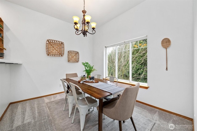 carpeted dining space featuring a notable chandelier and baseboards