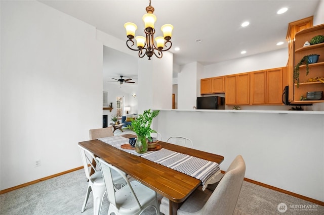 dining room with recessed lighting, light carpet, ceiling fan with notable chandelier, a fireplace, and baseboards