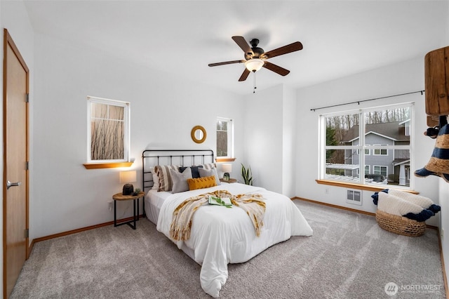 carpeted bedroom featuring ceiling fan and baseboards