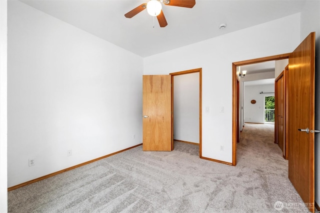 unfurnished bedroom with carpet, baseboards, and a ceiling fan