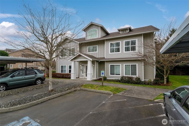 view of front of home featuring uncovered parking and board and batten siding